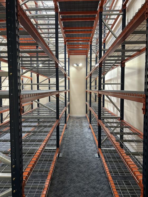 Looking up through a multi-tier racking structure with wire decking